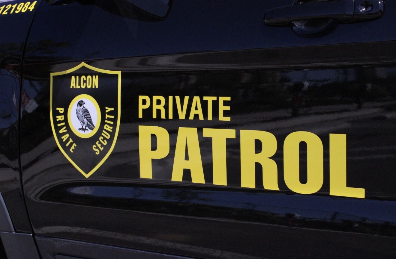 Close-up of the Alcon Private Security shield and Private Patrol lettering