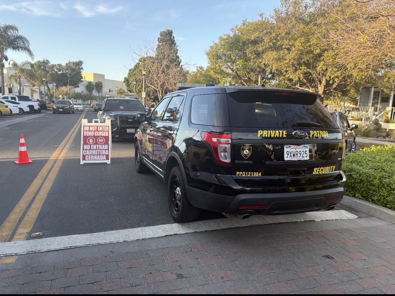Alcon security vehicle beside a road closure on a Central Coast street