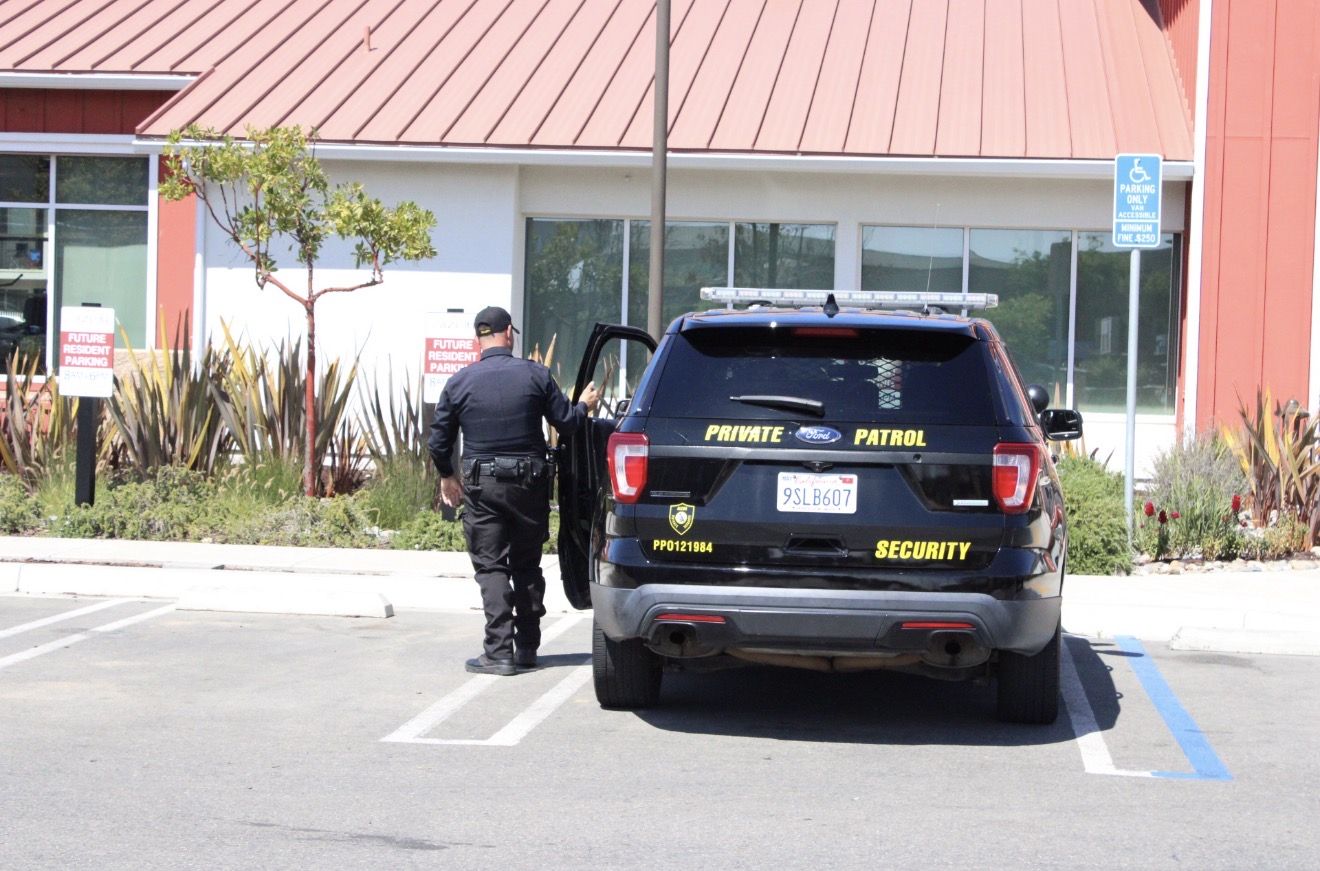Alcon officer stepping into the patrol SUV during a daytime check