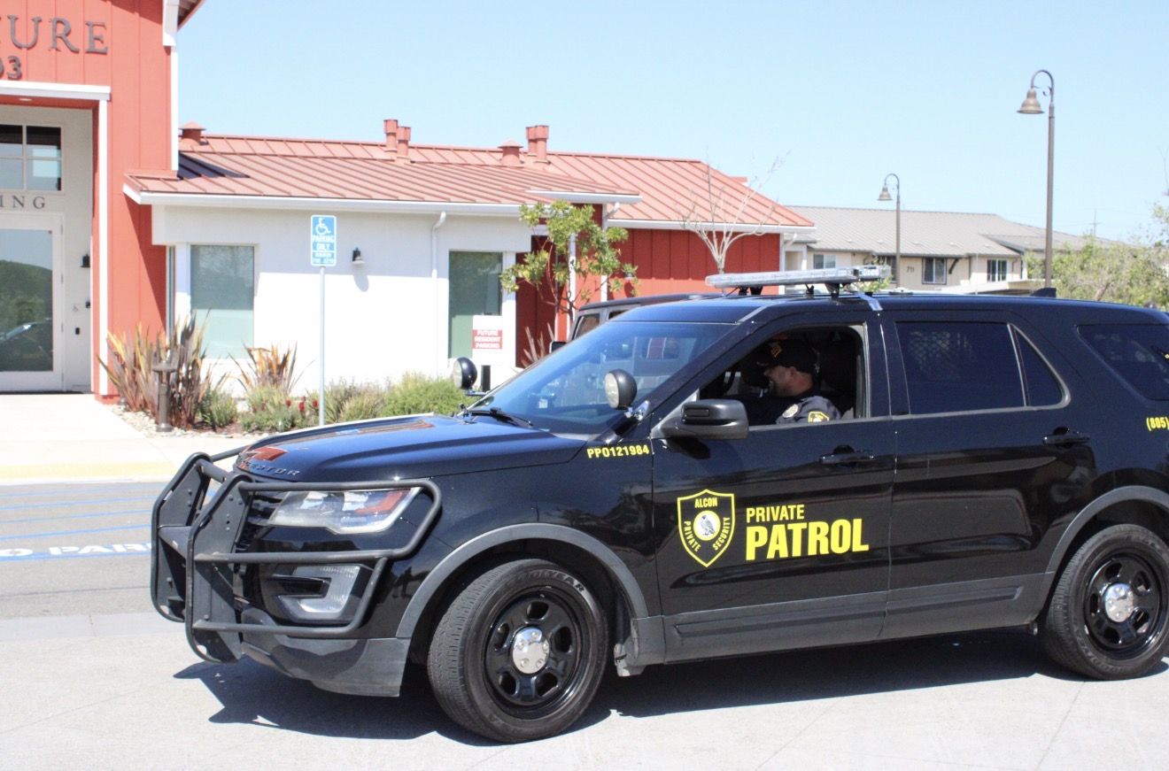 Alcon officer driving a marked Private Patrol SUV through a property